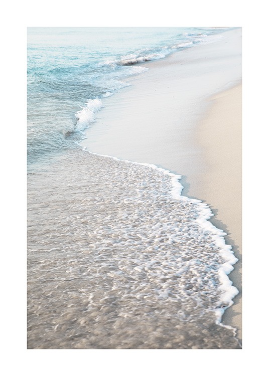  – Photograph of a beach with light sand and waves coming onto the beach