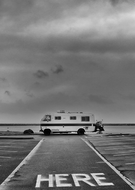  - Black and white retro poster of a old camper in an empty parking lot by the sea.