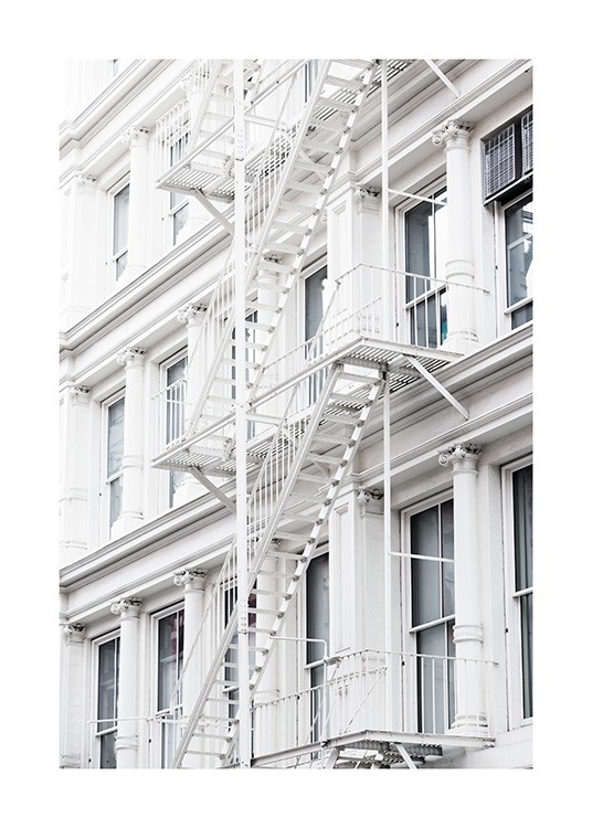  - Stylish shot of a white fire escape staircase attached to a building facade in New York.