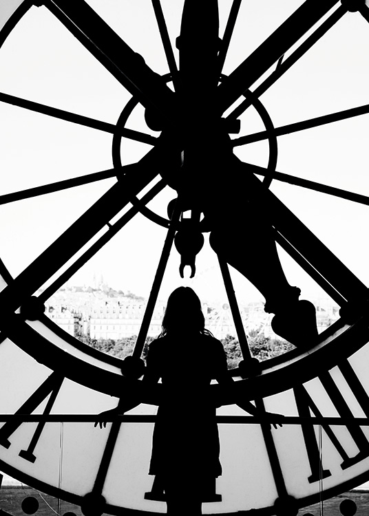  - Black and white photo poster of a woman in front of a large church clock in Paris.
