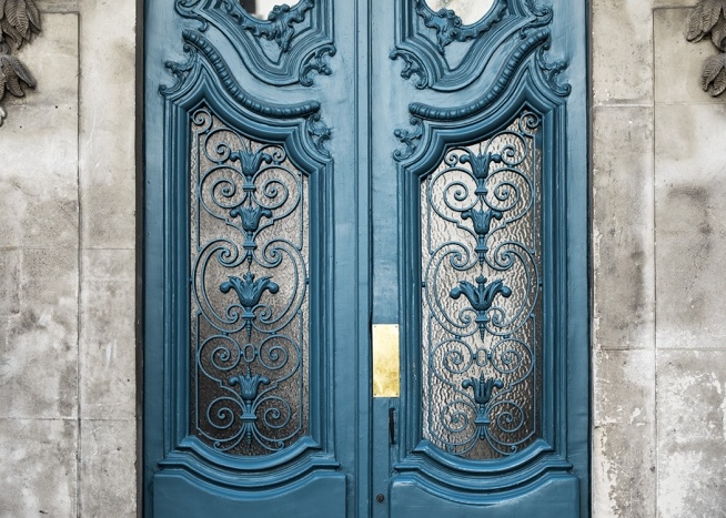  - Detailed shot of a blue front door in Paris beautifully decorated.