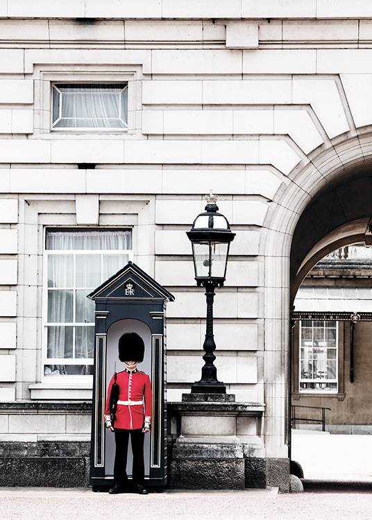   Palace  - Picture of a Queen's Guard in his red uniform standing in front of the royal residence of Buckingham Palace in London