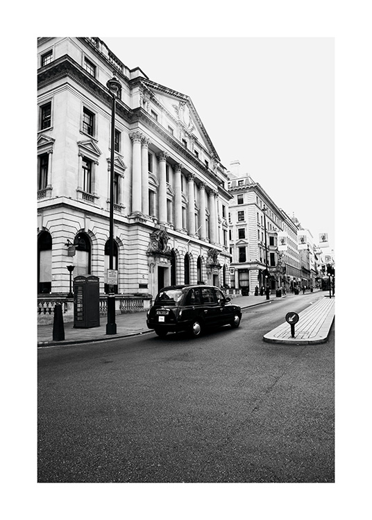- Black and white photo poster of a London taxi driving on the left.