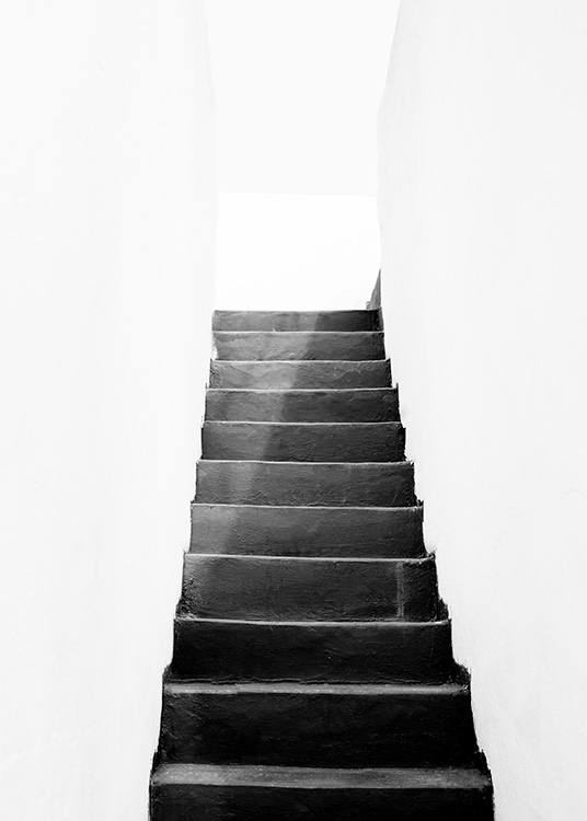 – Photograph of a dark stairway with white walls surrounding 