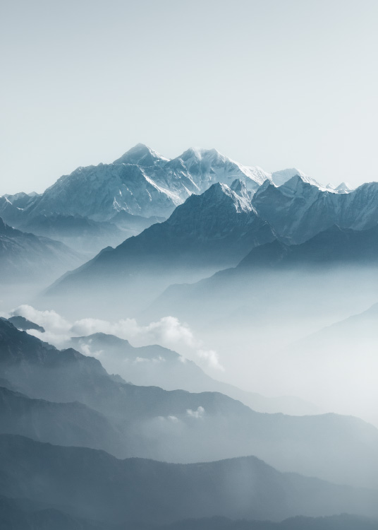 – Photograph of the alps with cloud sneaking through. 