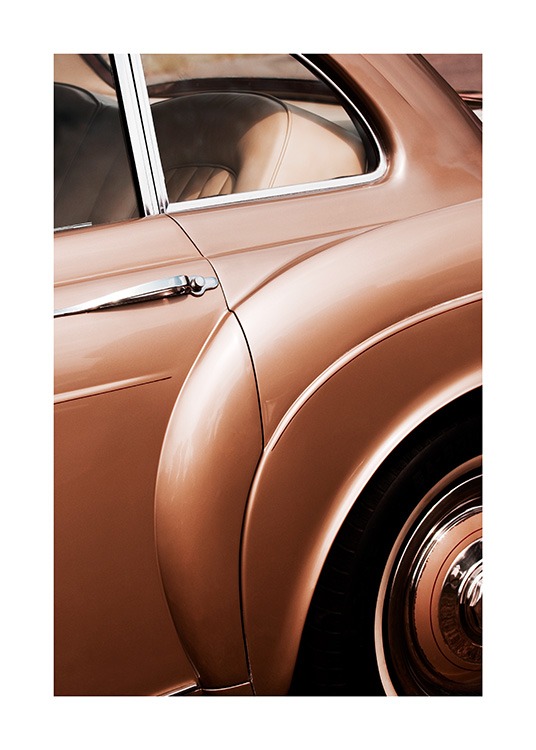  - Close up photograph of a vintage car in bronzed brown with silver details