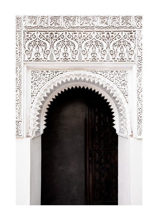  - Photograph of a black door and a white arch with handcrafted details and patterns