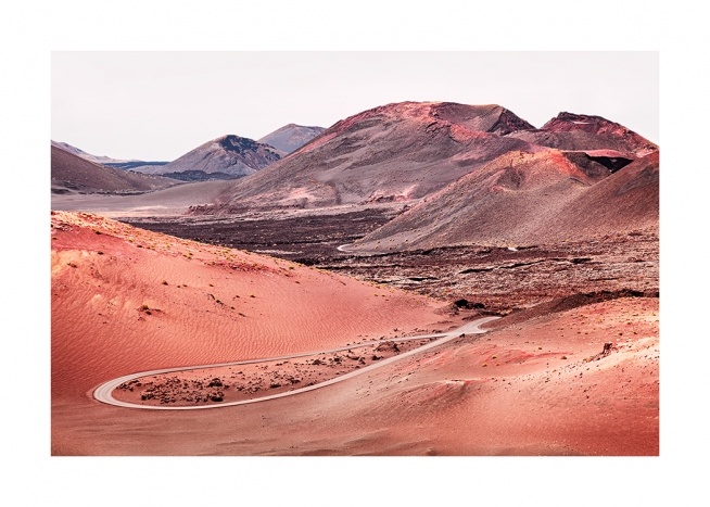  – Photograph of red sand in a volcanic landscape with mountains in the background