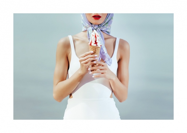  – Retro photograph of a woman holding an ice cream cone and wearing a white swimsuite and blue headscarf