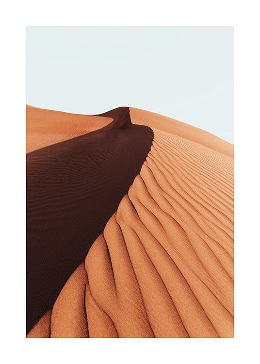  – Photograph of a sand dune in a desert with a light blue sky behind it