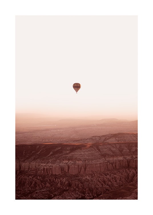  – Photograph of a mountain landscape with an air balloon flying over it