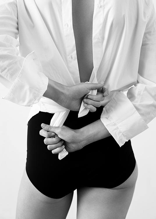  – Black and white photograph of a woman in high waisted panties, tying a shirt behind her back