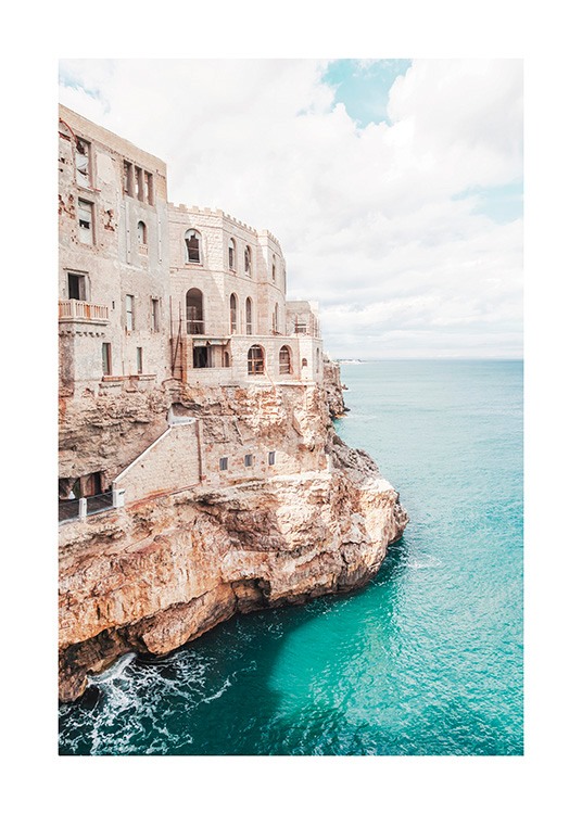  – Photograph of a cliff next to the ocean with a building on the cliff