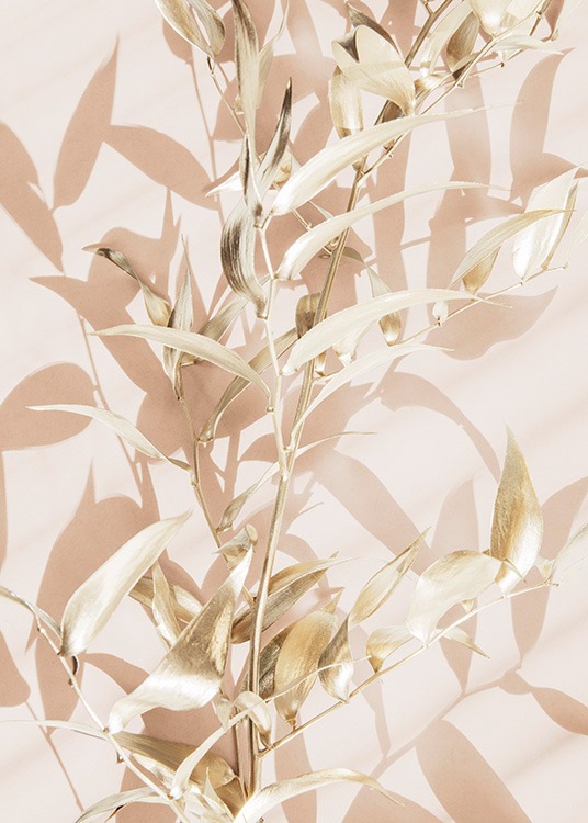  – Photograph of golden leaves with a light pink background behind them