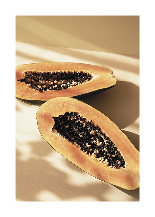 – Photograph of a papaya split in half with a yellow background