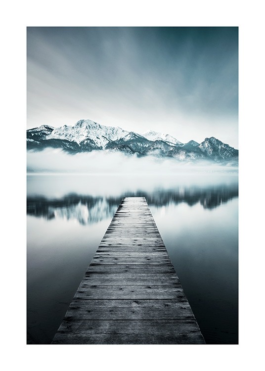  – Photograph of a still lake with mountains in the background and a jetty in the lake