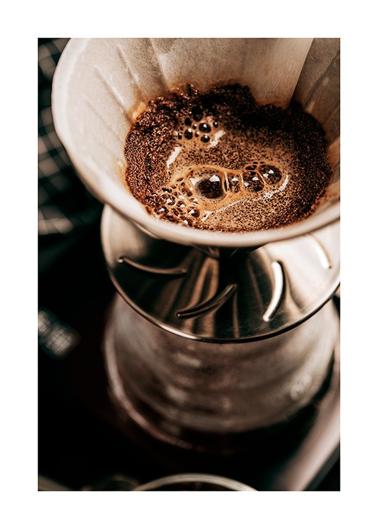  – Photograph with close up of a coffee filter filled with coffee grounds