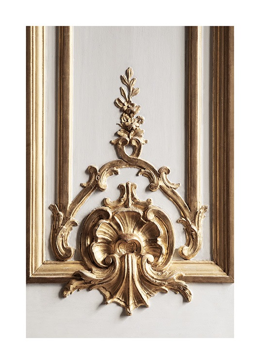  – Photograph of gold wall decor in a baroque style, on a grey wall