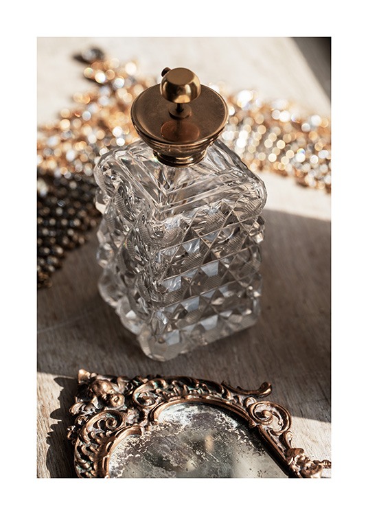  – Photograph of a retro bottle in glass with a gold lid, and a vintage mirror in front of it