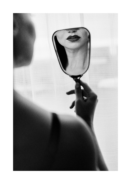  – Black and white photograph of a woman watching herself with dark lipstick in a small mirror