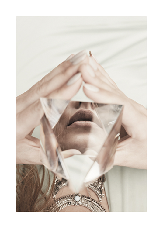 – Photograph of a crystal pyramid held by a woman, with her reflection in it