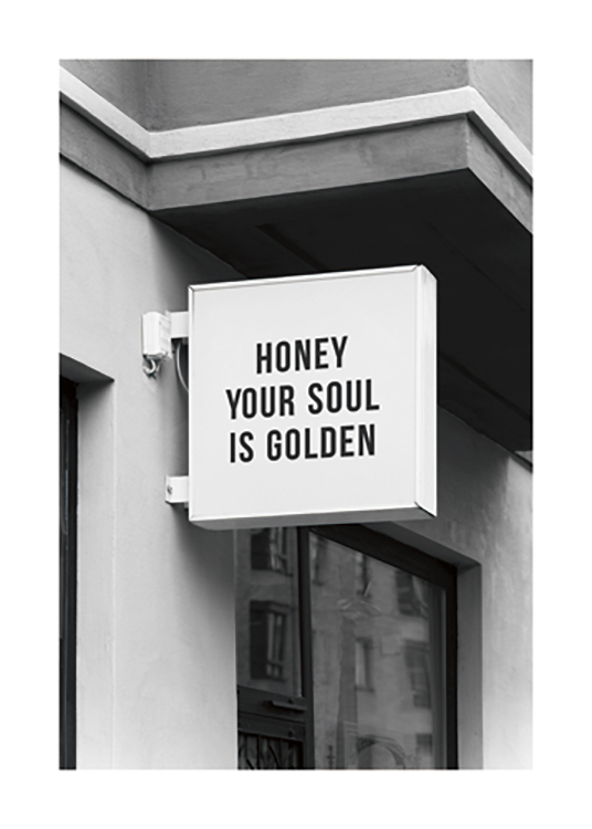  – Black and white photograph of a store sign with the text \