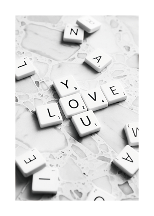  – Photograph of scrabble letters on a terrazzo background, forming the words Love You