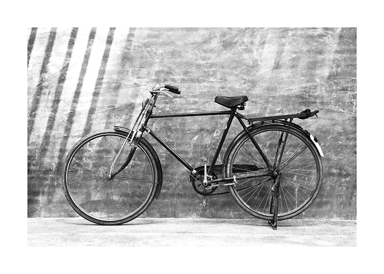 – Black and white photograph of an old, vintage bike standing against a wall