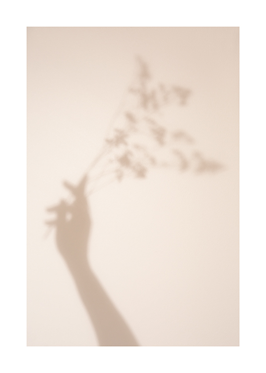  – Photograph of the shadow of a hand and flowers against a light beige background