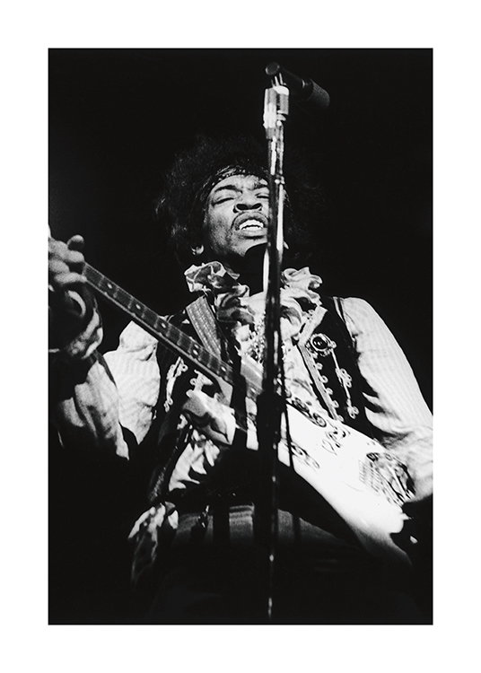  – Black and white photograph of the musician Jimi Hendrix playing guitar