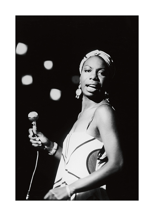  – Black and white photograph of Nina Simone holding a microphone