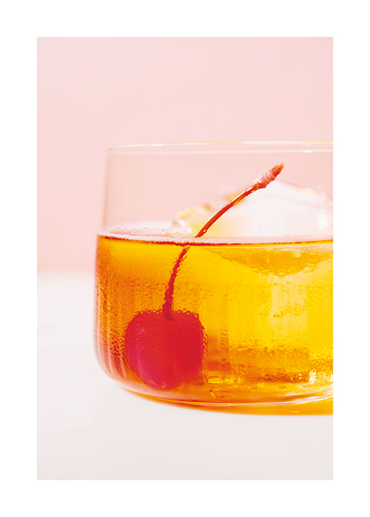  – Photograph with close up of a cherry in a yellow drink against a pink background