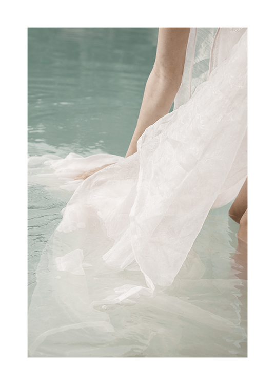  – Photograph of a person standing in water with a white fabric floating around them