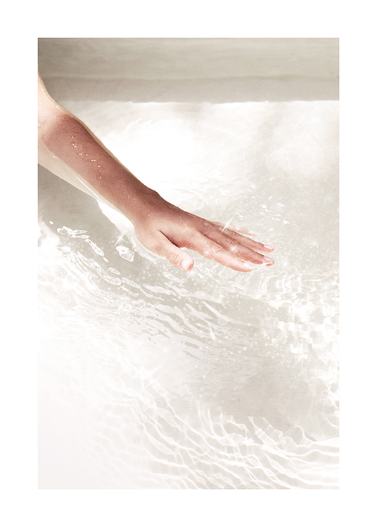  – Photograph of clear water with sparkling details and a hand brushing across the surface