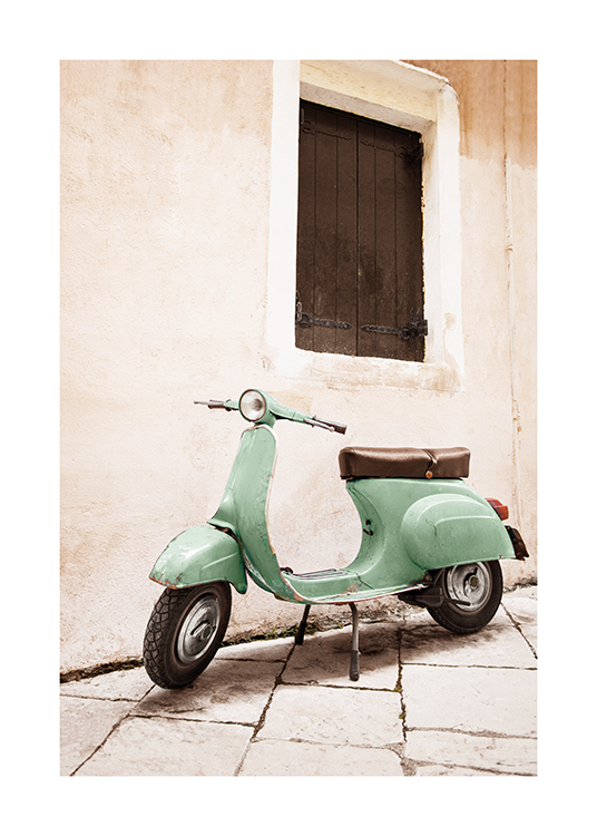  – Photograph of a vintage scooter in green, standing next to a house