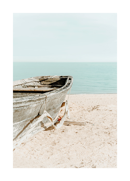 – Photograph of an old boat in the sand on a beach with the sky and ocean in the background