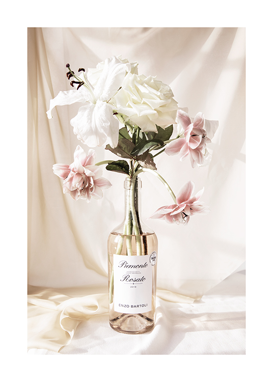  – Photograph of a bouquet with pink and white flowers in a bottle of rosé