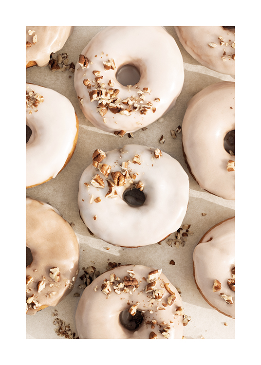  – Photograph of a bundle of donuts with beige and white frosting and nut topping