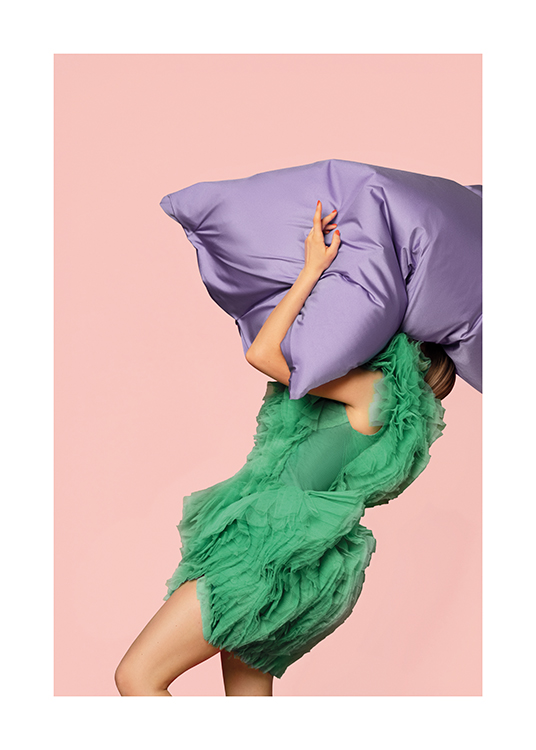  – An image of a woman in a green tulle dress carrying an oversized pillow