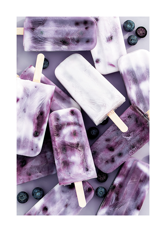  – Photograph of blueberries and blueberry popsicles laying on a purple background