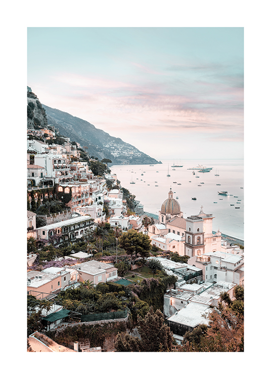  – Photograph of buildings and houses in Positano, with boats in the ocean in the background