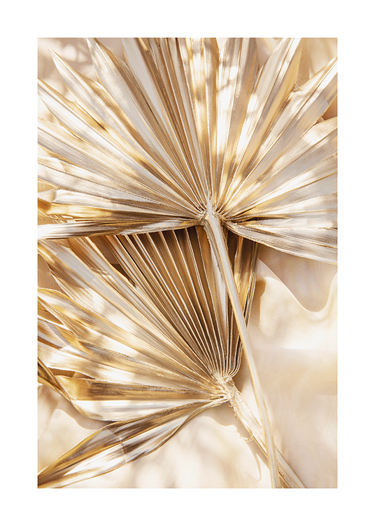  – Photograph of a pair of pleated palm leaves in gold with some sun shining on them