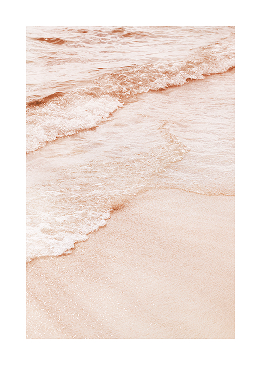  – Photograph of a peach/pink beach and sea with the water coming onto the sand