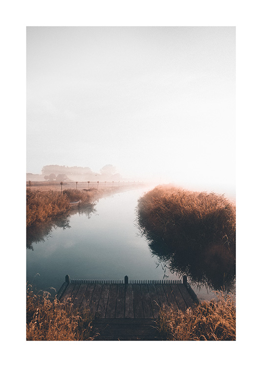  – Photograph of a calm lake with a foggy landscape in the background and a little jetty in the foreground
