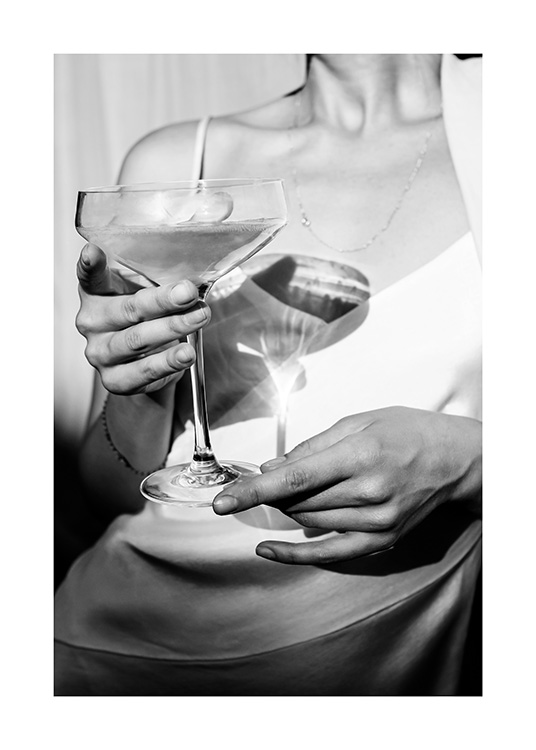  – Black and white photograph of a woman holding a glass of champagne