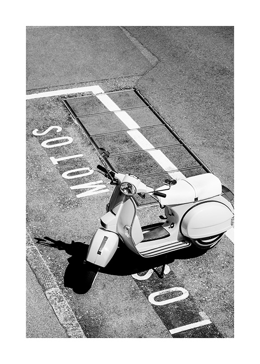  – Black and white photograph of a retro scooter standing on a parking lot with text written on the ground