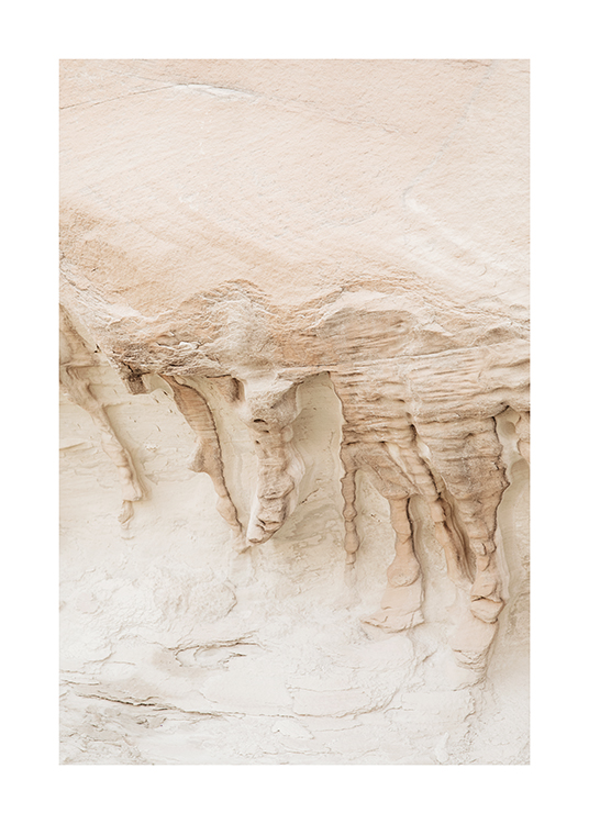 – Photograph of a sand and rock landscape in beige with formations on the cliffs