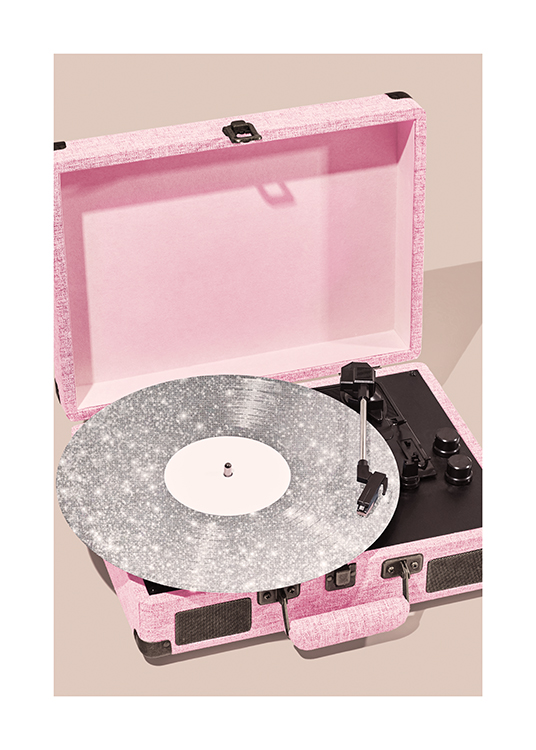 – Photograph of a pink record player with a silver sparkling vinyl in it