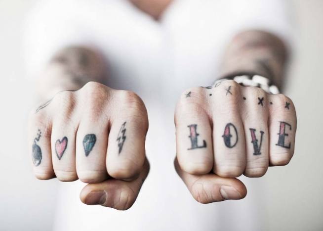  - Modern photo art with a love tattoo on a person’s fist.