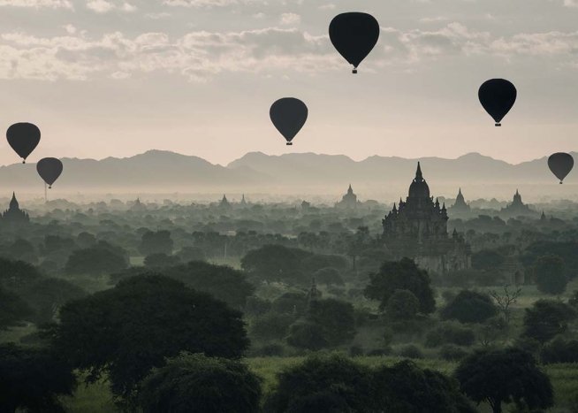  - Great photo art with several hot-air balloons in a magical green landscape.